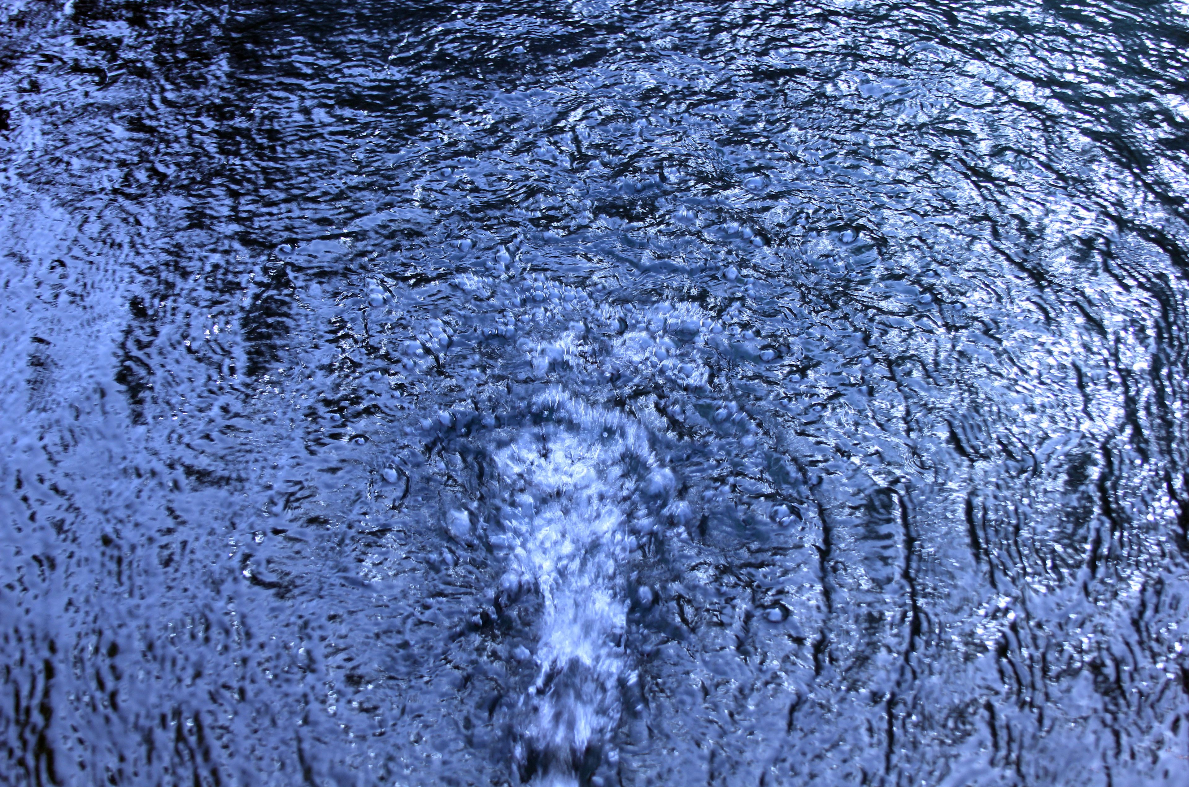 A close-up of water with ripples and splashes.