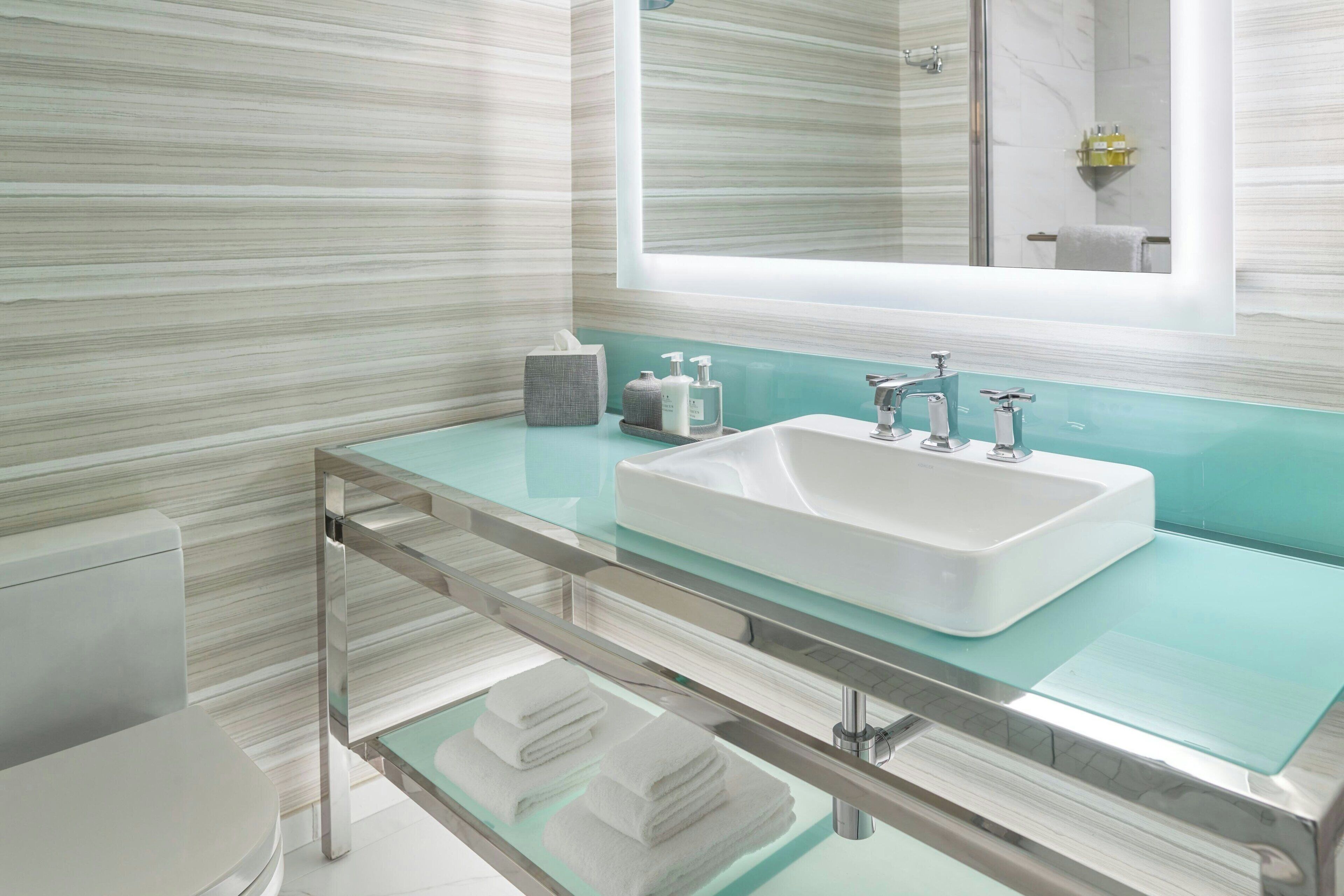 designer toiletries, hair dryer, towels