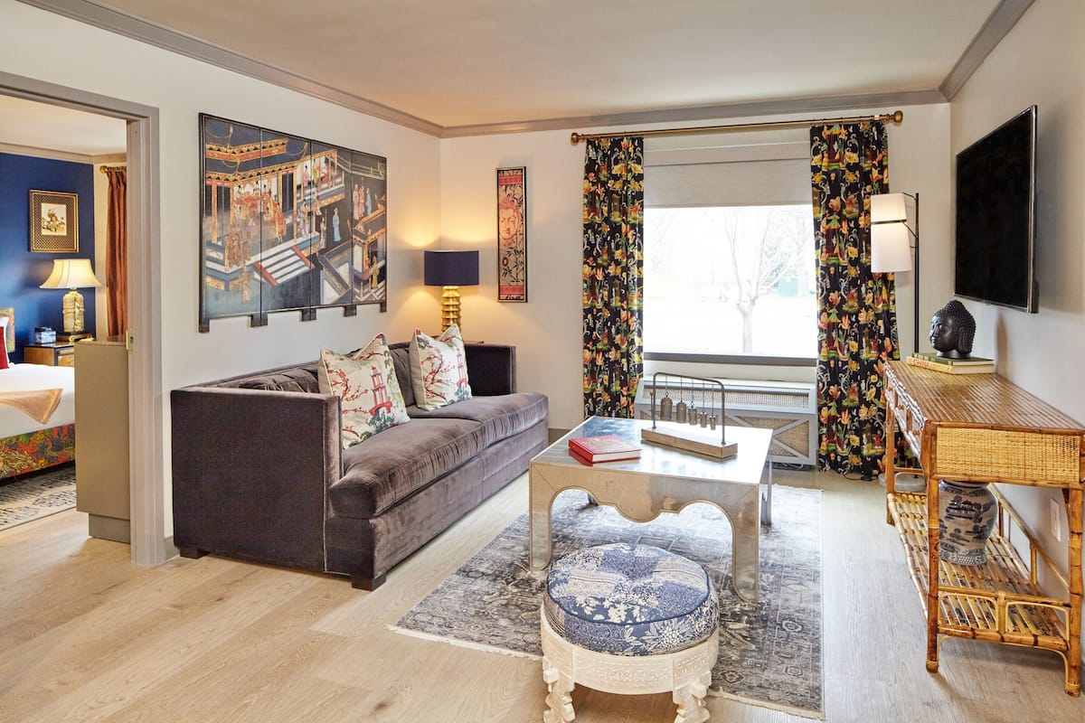 A living room with a sofa, coffee table, and decorative items.