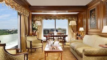 A luxurious room with a balcony, a dining table, and a sofa.