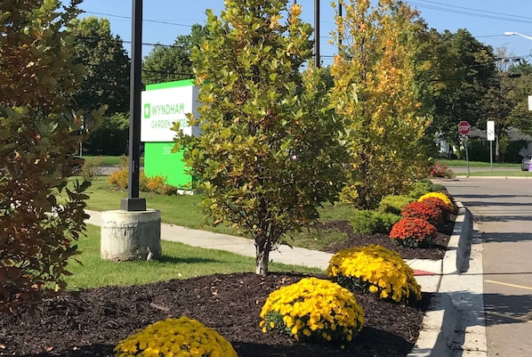 A garden with a sign for 'Wyndham Garden Center' and a stop sign.