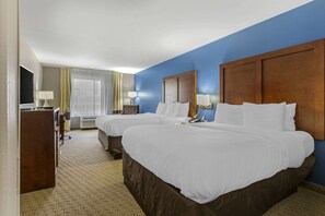 A hotel room with two beds, a TV, a desk, and a window with curtains. - Comfort Inn Garner Clayton I-40 (Garner)