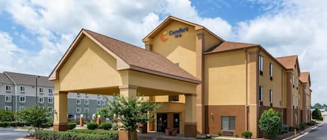 Un hotel Comfort Inn con entrada cubierta, varios pisos y estacionamiento.