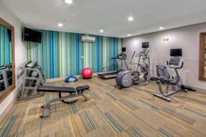 A gym with various exercise equipment including treadmills, an elliptical, and free weights. - Holiday Inn Express & Suites Crossville by IHG (Crossville)