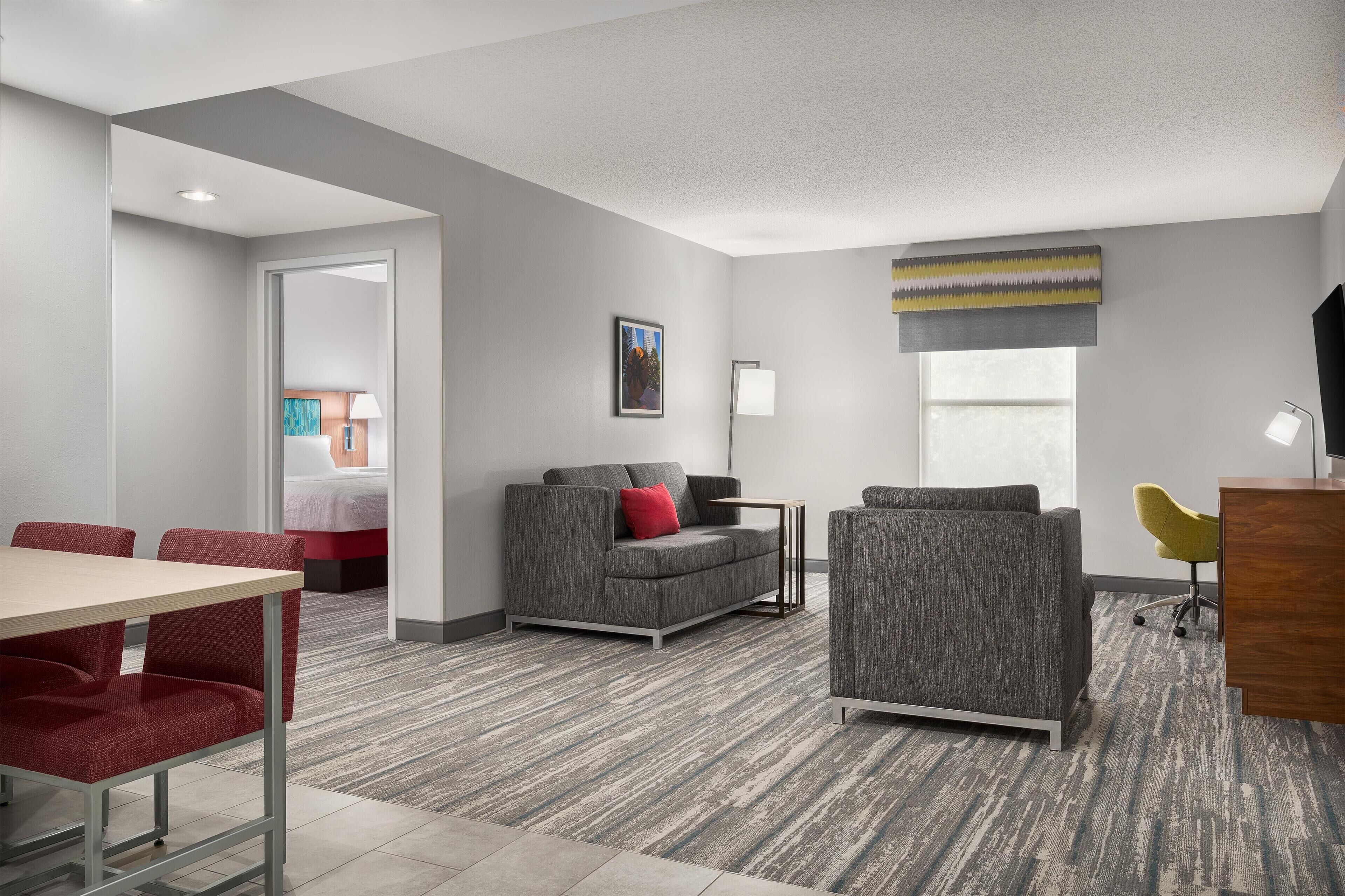 Suite, One King Bed, Non-Smoking | Living area | 55-inch TV with cable channels