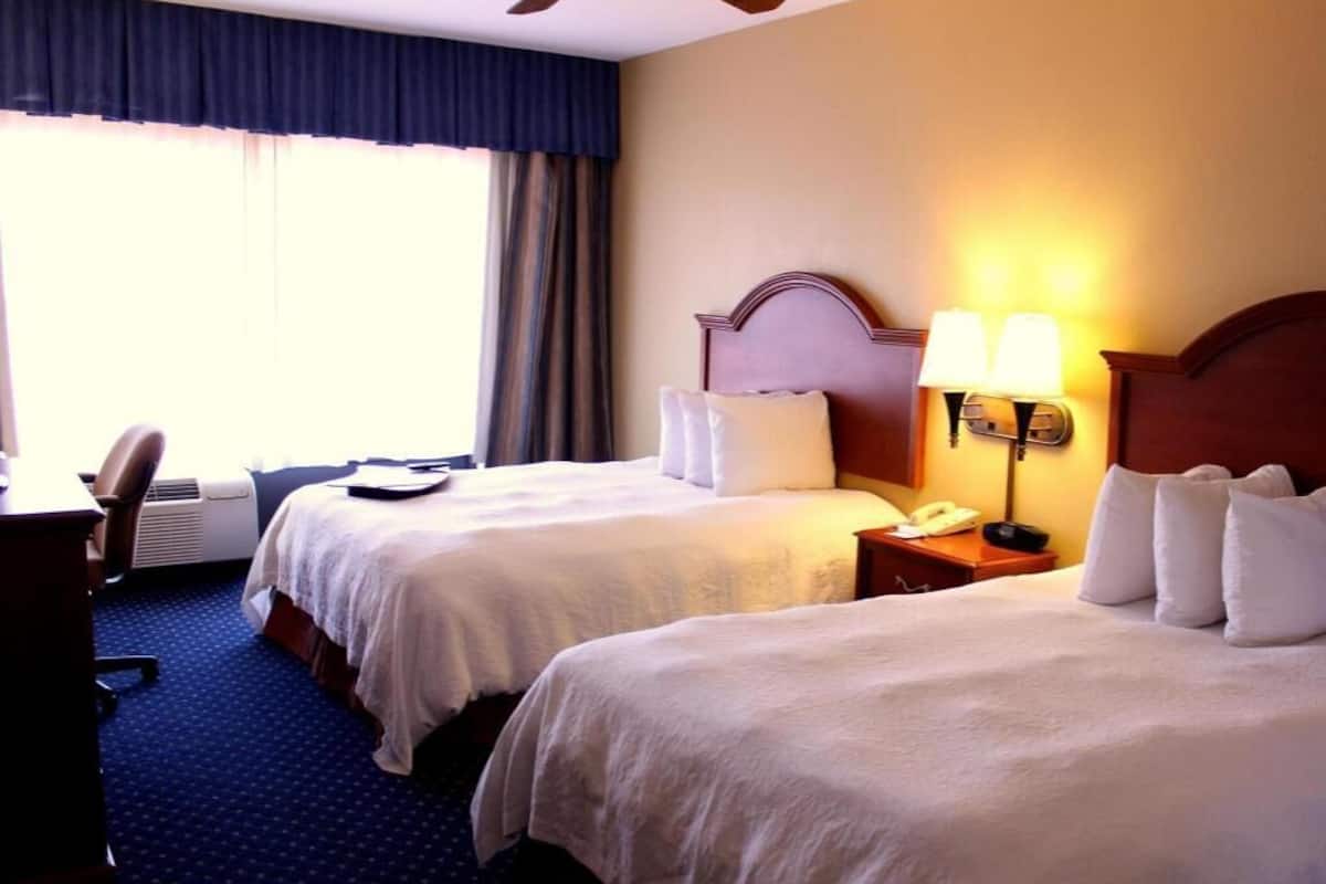 Premium bedding, desk, laptop workspace, blackout curtains