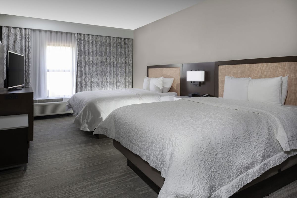 Premium bedding, desk, laptop workspace, blackout curtains