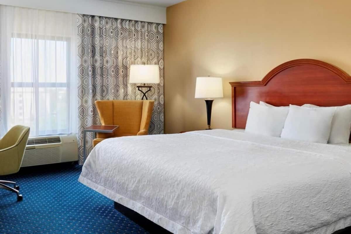 Premium bedding, desk, laptop workspace, blackout curtains