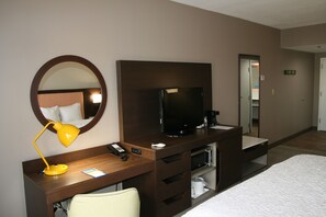 Premium bedding, desk, laptop workspace, blackout drapes
