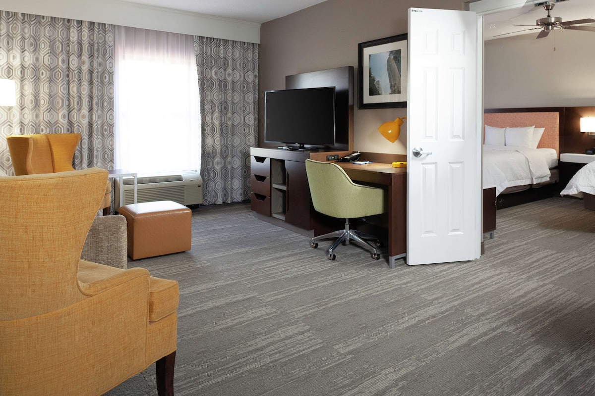 Premium bedding, desk, laptop workspace, blackout drapes