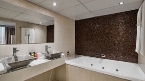 Features two large vessel sinks and a bathtub.
