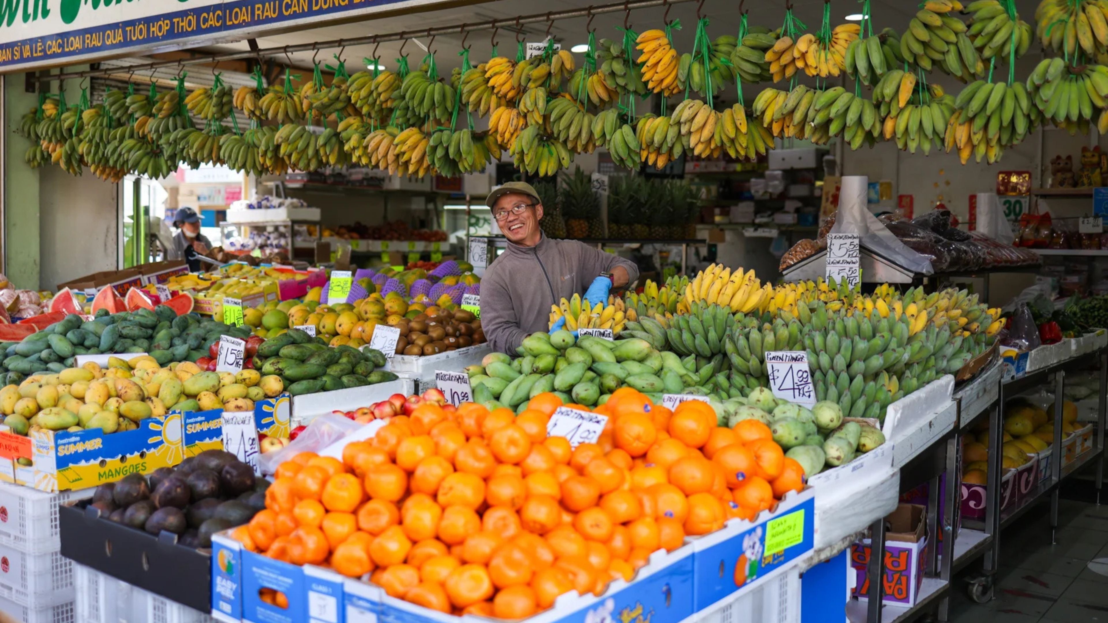 A fruit market with various fruits and vegetables on display.