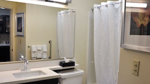 A bathroom with a sink, toilet, and bathtub.