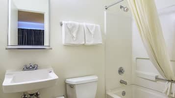 A bathroom with a sink, toilet, and bathtub.