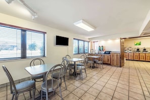 Enjoy meals in the kitchen area with a flat-screen TV and dining tables.