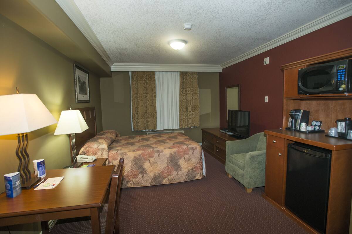 traditional double room single use, 2 queen beds | premium bedding, desk, iron/ironing board, free cots/infant beds