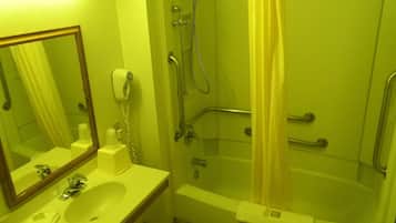 A bathroom with a sink, mirror, shower, and toilet.