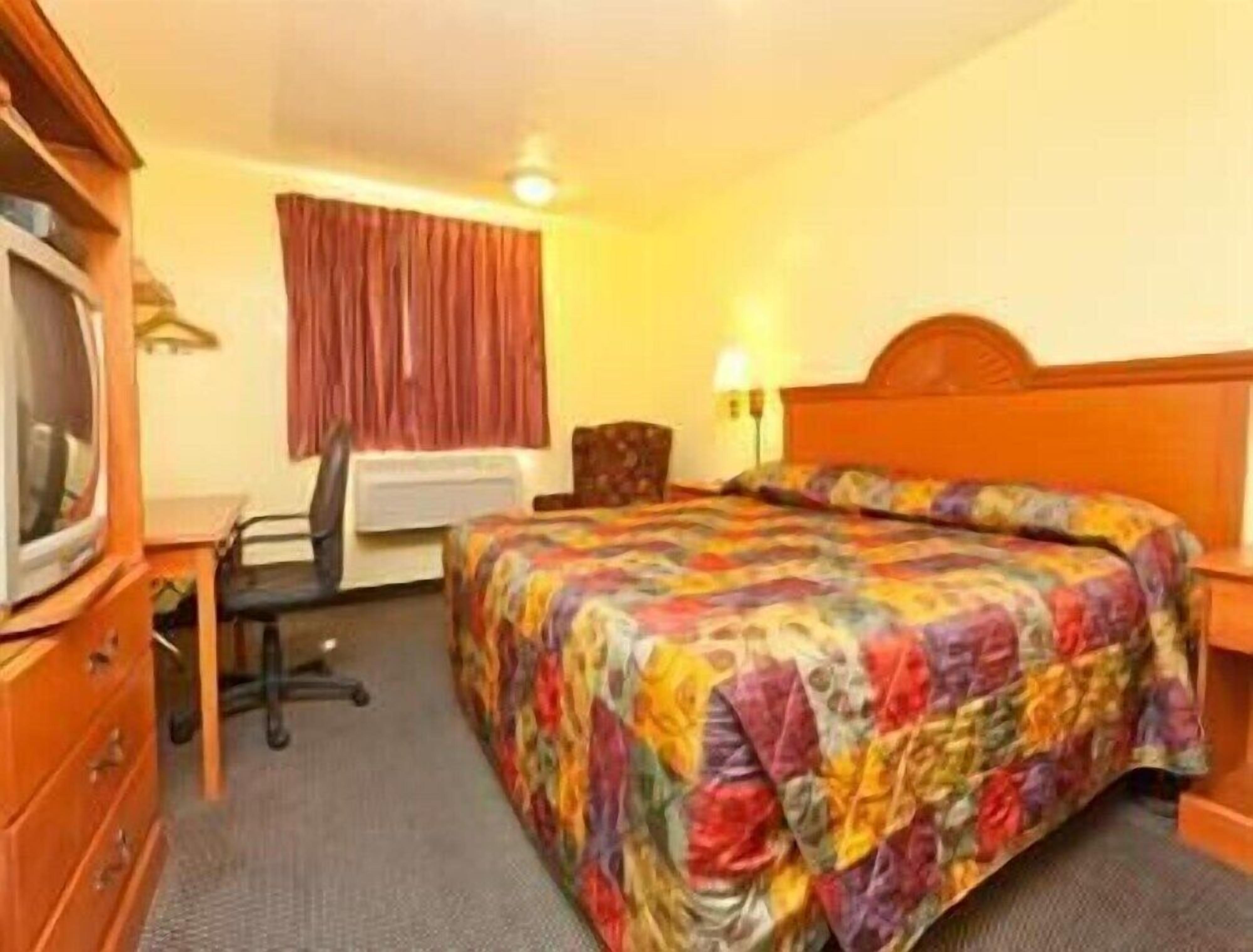 Desk, laptop workspace, bed sheets