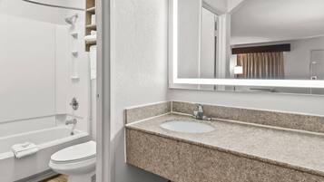 A modern bathroom with a shower, toilet, and sink.