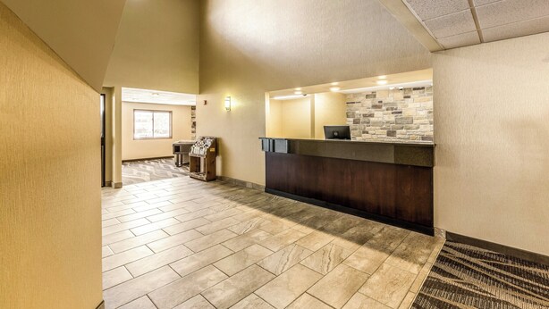 A reception area with a stone wall, a reception desk, and a tiled floor.