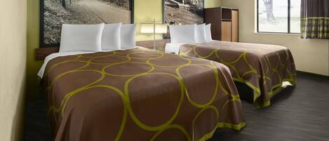 A hotel room with two beds, a nightstand, a lamp, and a window with curtains.