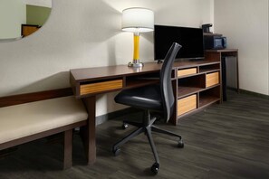 A hotel room with a wooden desk, a black office chair, a television, and a coffee machine. - Super 8 by Wyndham St. Clairsville OH/Wheeling WV Area (St. Clairsville)