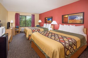 A hotel room with two beds, a desk, a television, and a window with curtains.
