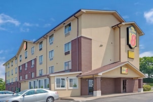 A multi-story hotel with a beige and brown facade, multiple windows, and a prominent 'Super 8' sign.