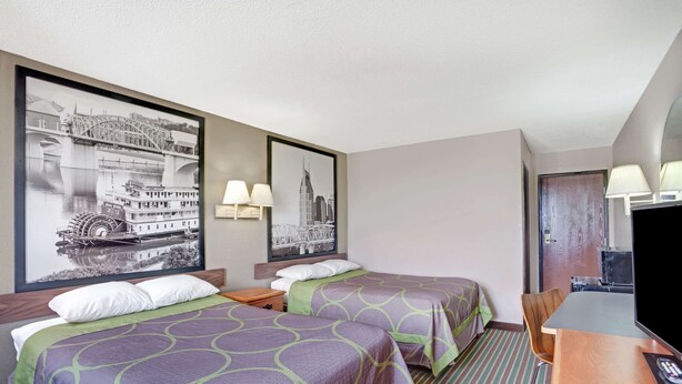 A hotel room with two beds, a desk with a TV, and two wall-mounted lamps. - Super 8 by Wyndham Nashville/ Dntn/ Opryland Area (Nashville)