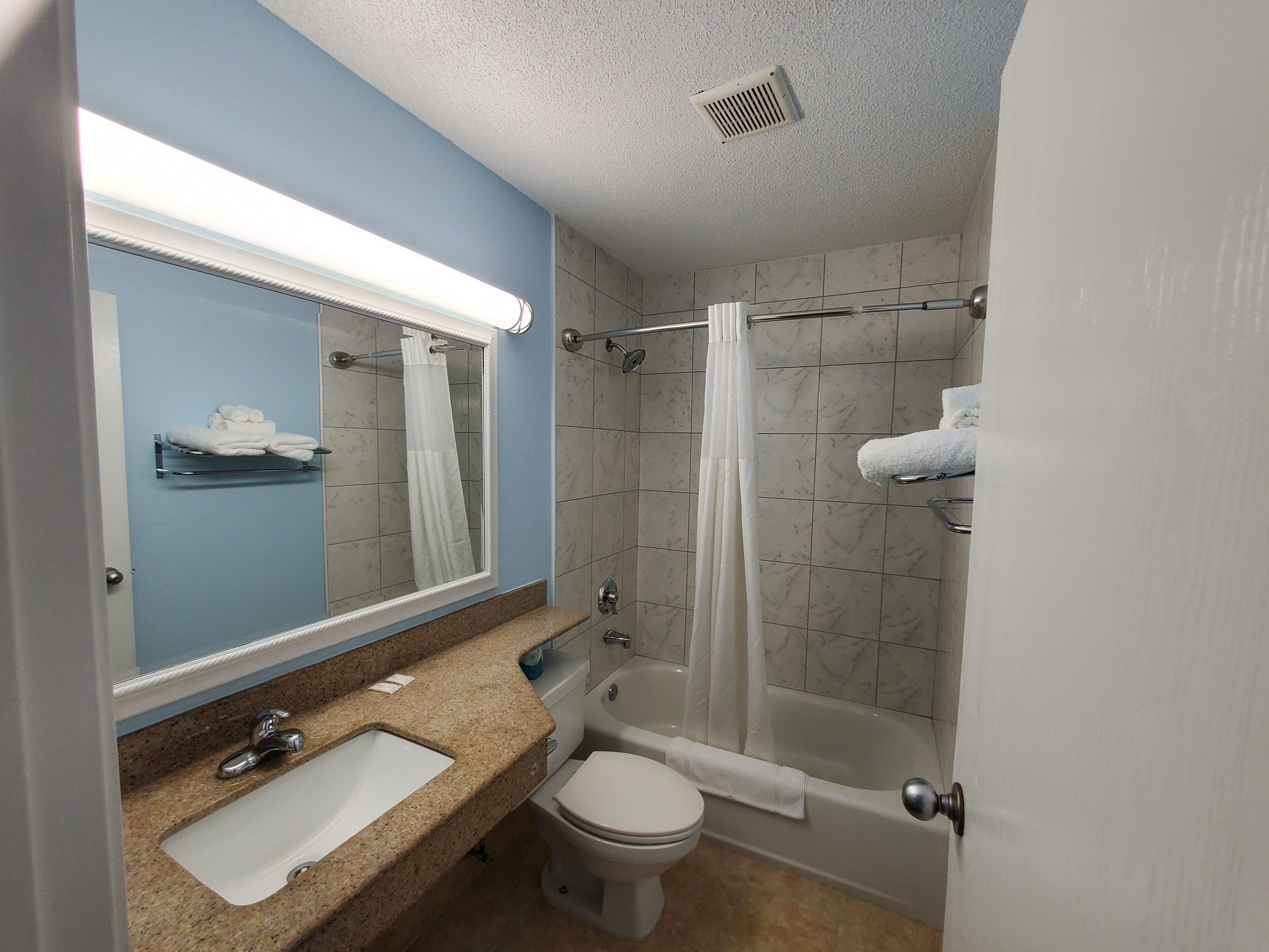 A bathroom with a sink, toilet, and bathtub.