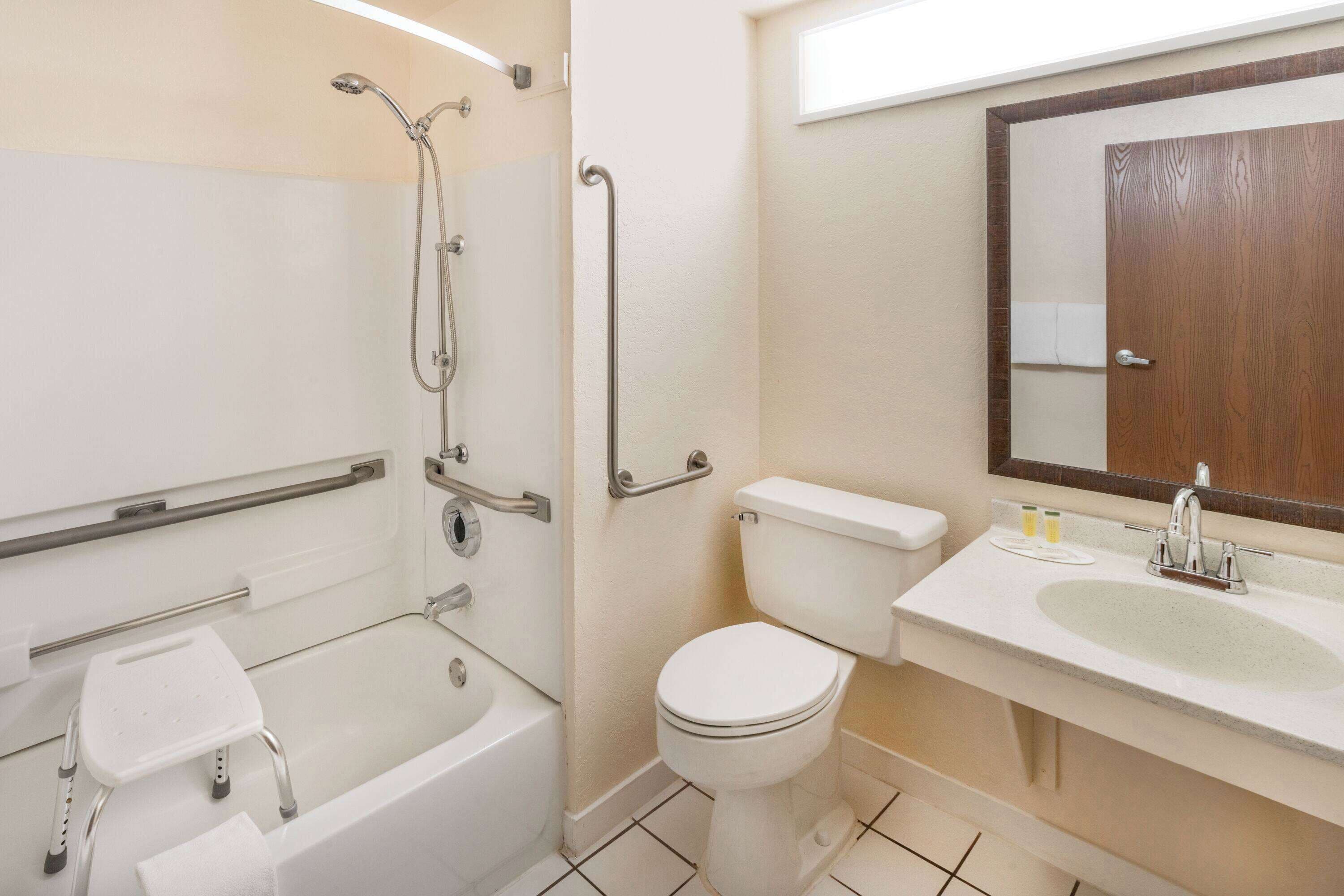 A bathroom with a bathtub, a toilet, a sink, and a shower.