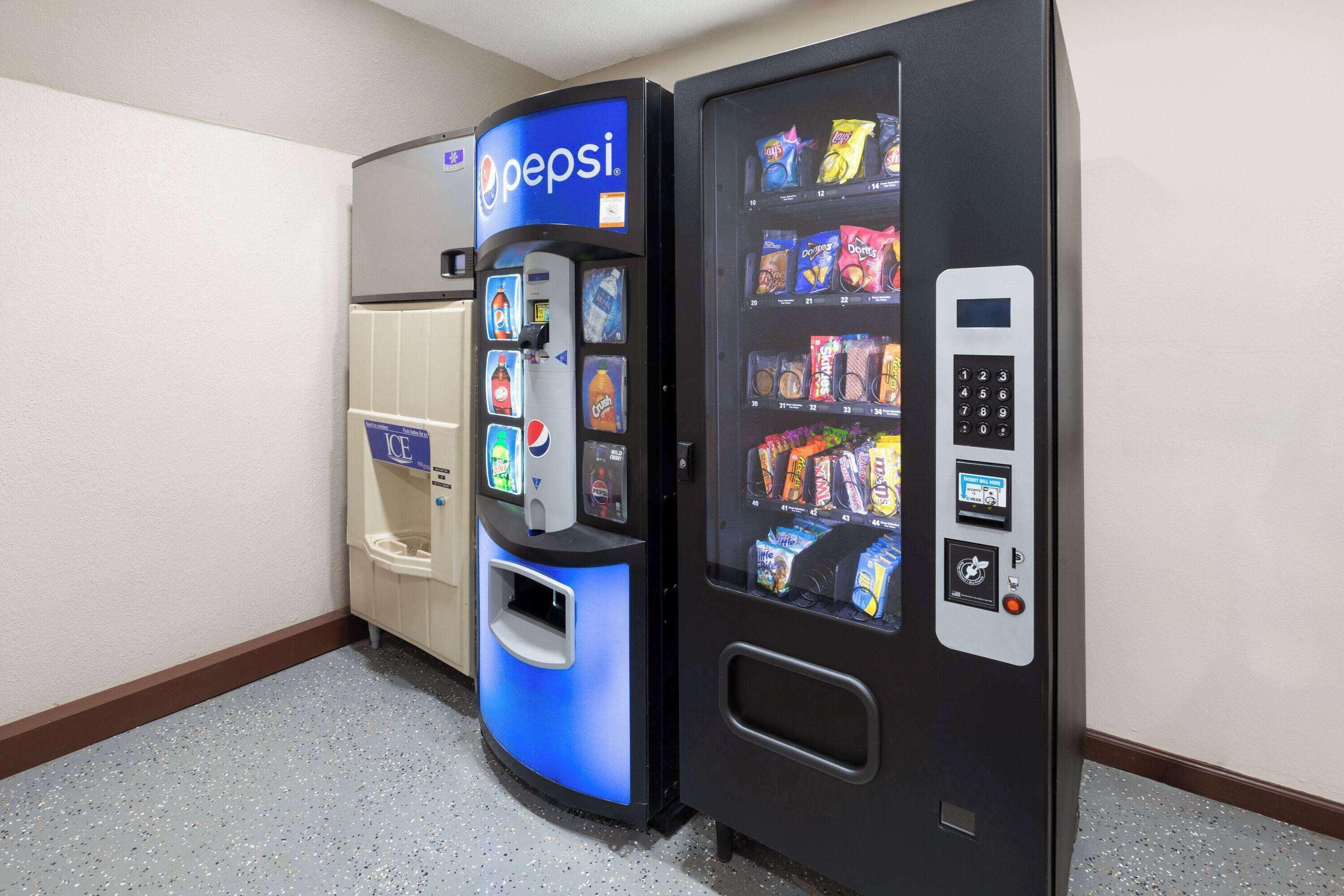 A vending machine with a Pepsi logo and a snack vending machine next to it.