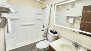 A bathroom with a bathtub, toilet, sink, and a mirror. - Super 8 by Wyndham Anderson/Clemson Area (Anderson)