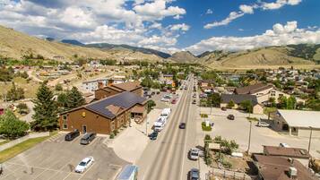 A town with a main road, buildings, and mountains in the background.