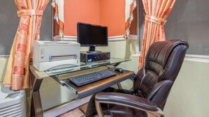 A home office setup with a computer, printer, and leather chair. - Super 8 by Wyndham Portales (Portales)
