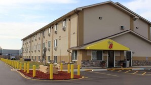 A hotel with a yellow awning and a sign that reads "Super 8". - Super 8 by Wyndham Wyoming/Grand Rapids Area (Wyoming)