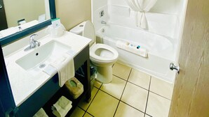 A bathroom with a sink, toilet, and shower. - Super 8 by Wyndham Wyoming/Grand Rapids Area (Wyoming)