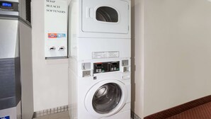 A front-loading washing machine with a control panel, a soap and bleach softener dispenser, and a water heater. - Super 8 by Wyndham Marietta (Marietta)