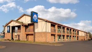A two-story brick building with a sign for 'Americas Best Value Inn'. - Americas Best Value Inn Livonia Detroit (Livonia)