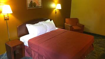 A hotel room with a bed, two nightstands, a chair, and two wall-mounted lamps.