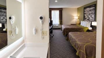 A hotel room with a large bathroom sink, two beds with matching headboards, a mirror, and a painting on the wall.