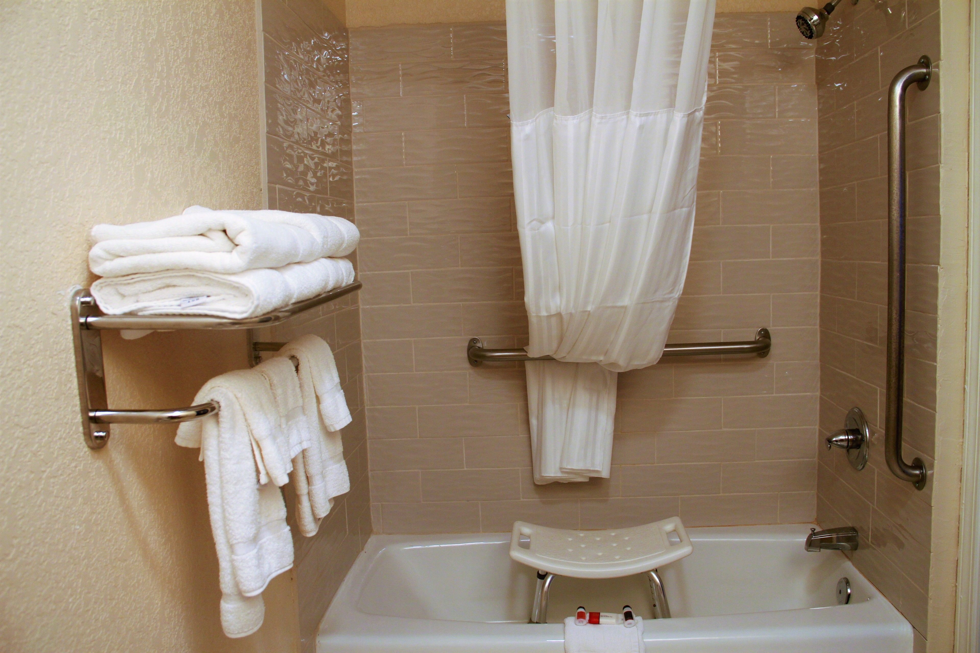 combined shower/bathtub, designer toiletries, hair dryer, towels