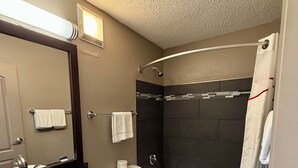 A modern bathroom with a sink, toilet, bathtub, and shower. - Baymont by Wyndham Findlay (Findlay)