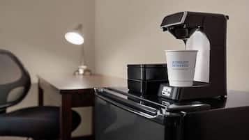 A coffee machine dispensing coffee into a cup labeled 'Wyndham Rewards'.
