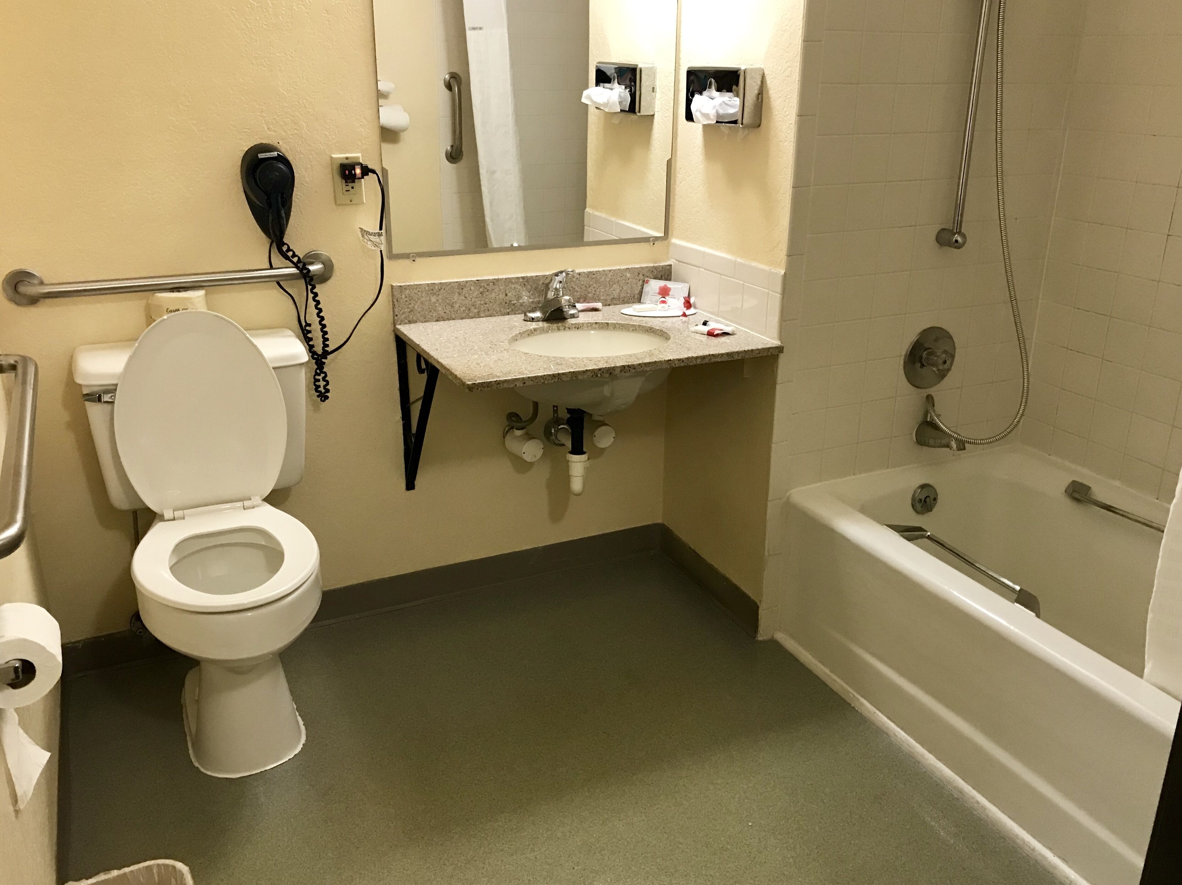 A bathroom with a toilet, sink, and bathtub.