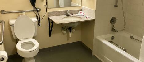 A bathroom with a toilet, sink, and bathtub.