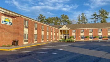 Stylish hotel with a central entrance and covered walkway.