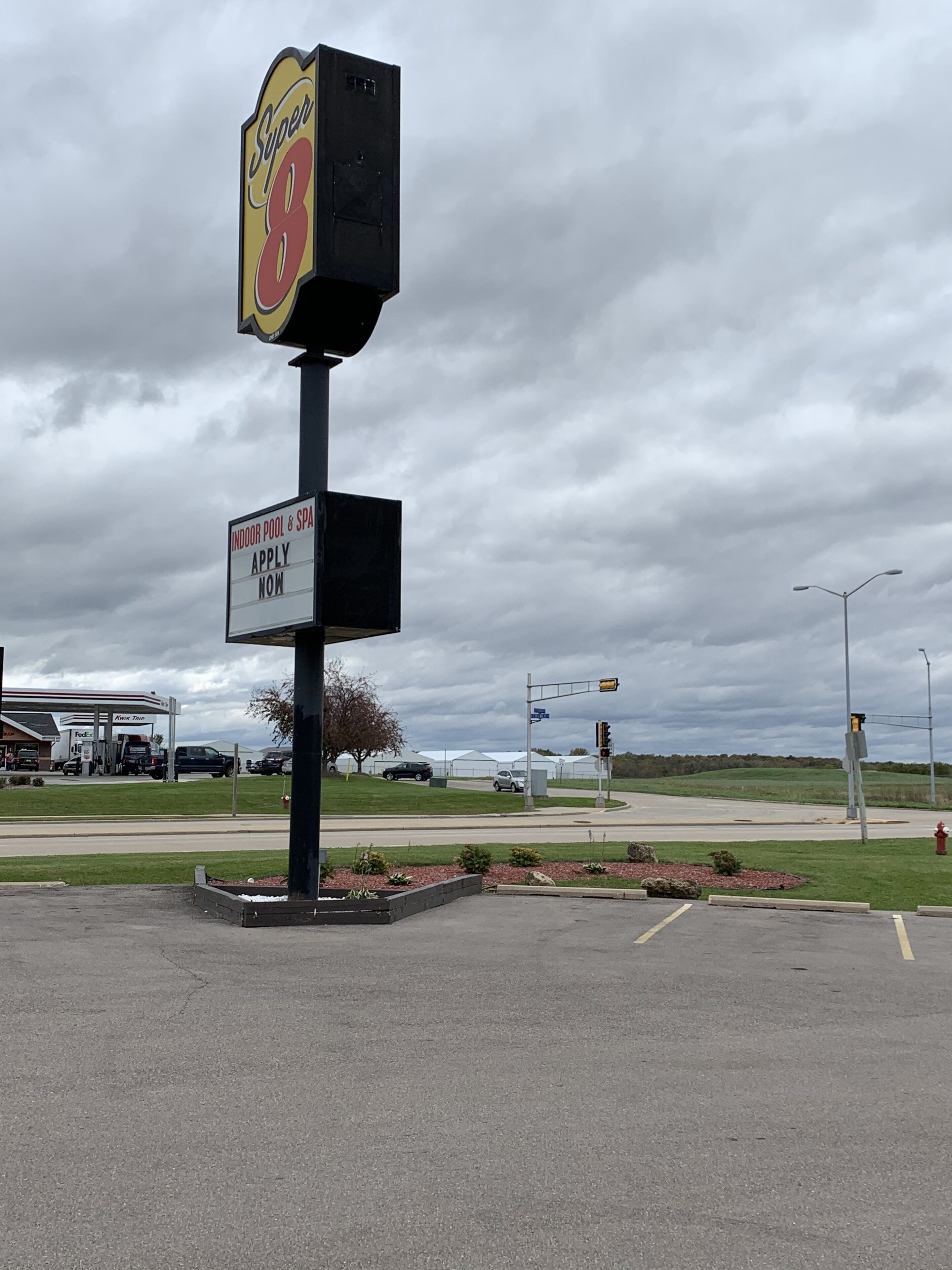 A sign for a hotel with a 'Super 8' logo and an 'Apply Now' sign below it.
