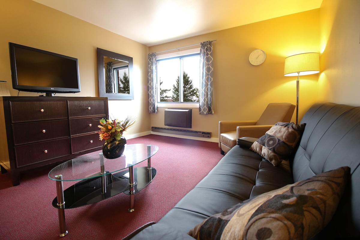 traditional suite, multiple beds | living area | tv