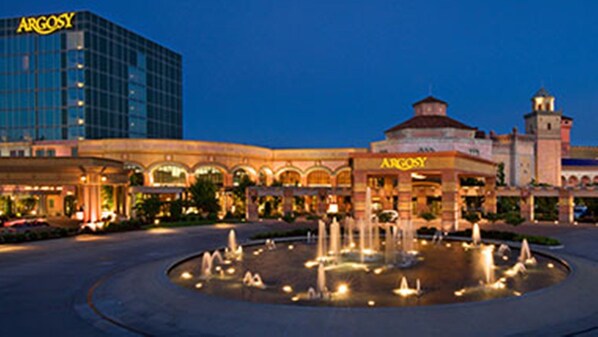 A hotel with a central fountain, a large building with 'ARGOSY' signage, and a tower.